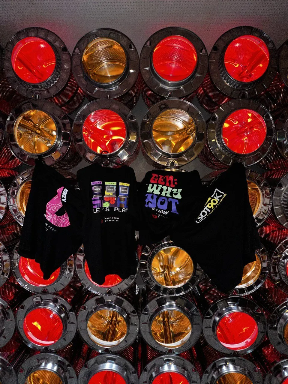 SOT90K and BRZY tees hanging against a wall of red and amber lights