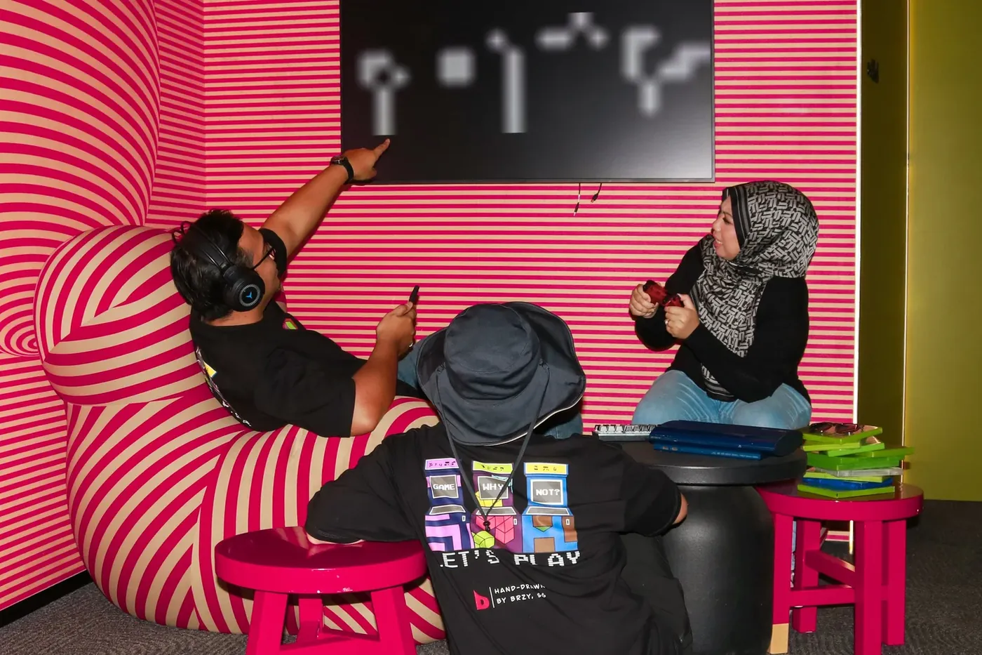 Game: Why Not? crew gaming in a pink striped room
